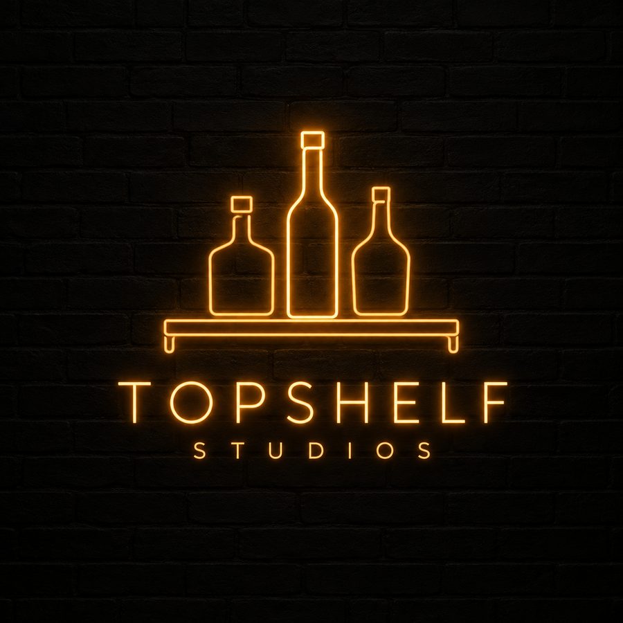 TopShelf Studios neon sign: three bottles glowing amber on a shelf against a dark brick wall